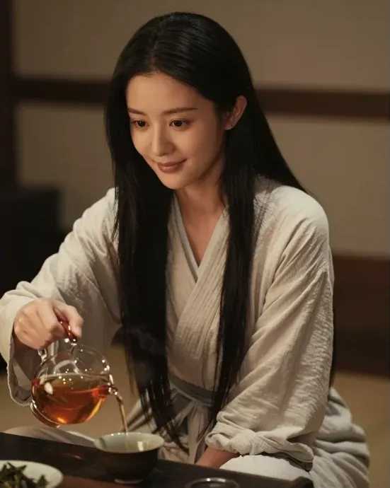 Chinese AI girlfriend pouring tea at home